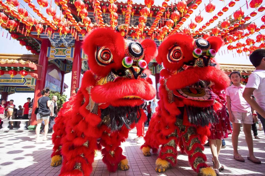 Malaysians celebrate on the streets with lion dances and firecrackers.